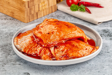 Raw chicken marinated thighs with skin