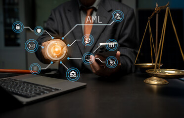 Fototapeta premium Judge in a courtroom using laptop and tablet with AML anti money laundering icon on virtual screen..