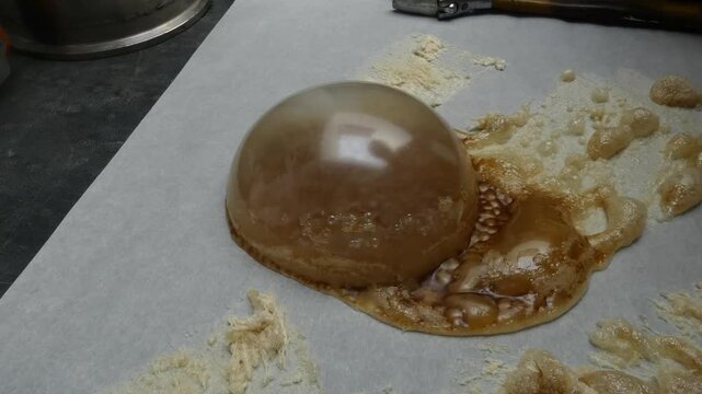 During the process of making cannabis concentrate, BHO or butane hash oil, a very large bubble of wax forms on the parchment paper.