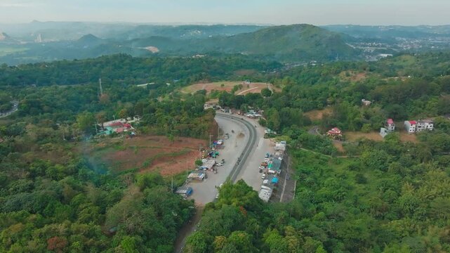 Aerial view of a paved road passing through a rural village in Calamba, Laguna, Philippines