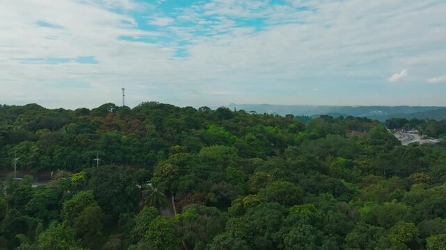 Rising-up drone footage of a paved road passing through in a rural village in, Laguna, Philippines