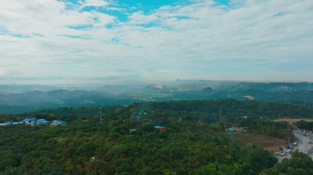 Aerial view of the thick green vegetation and rural buildings in Calamba, Laguna, The Philippines