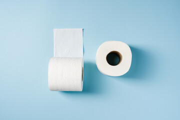 Top view of toilet paper roll on blue background