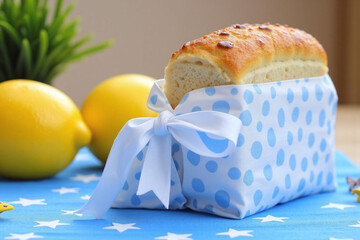 loaf of bread sitting on top of a blue and white table cloth
