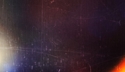 Blur colorful warm rainbow light leaks on black background with dust texture. Defocused abstract damaged scratched retro film analog effect for using over photos as overlay or screen filter