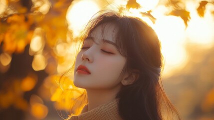 Fototapeta premium Serene Young Woman Amidst Golden Autumn Leaves