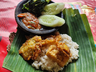 Egg salad. Rice with fresh vegetables, with traditional Indonesian chili sauce, with fried egg as a side dish.