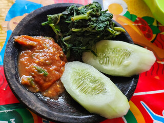 Egg salad. Rice with fresh vegetables, with traditional Indonesian chili sauce, with fried egg as a side dish.
