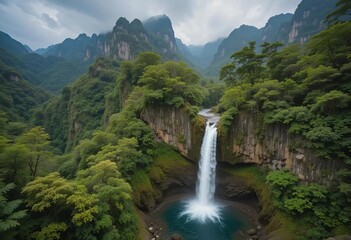 Aerial view of a waterfall surrounded by lush green forests and mountains in Tahiti