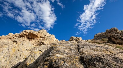 Fototapeta premium Stunning rock formation under a bright blue sky with fluffy clouds and natural scenery : Generative AI
