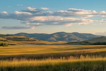 Rolling Hills and Plains in Montana with Distant Mountains, Tall Grasses, and Small Lakes Under a Blue Sky with Clouds, Captured in Golden Hour Lighting