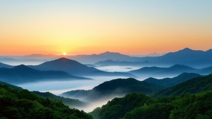 Obraz premium Misty Mountain Sunrise Layers of Blue and Green Hills Bathed in Golden Light