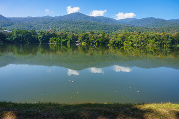 a public place leisure travel landscape lake views at Ang Kaew Chiang Mai University and Doi Suthep nature forest Mountain views spring cloudy sky background with white cloud.