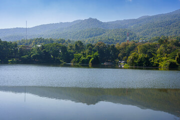 Obraz premium a public place leisure travel landscape lake views at Ang Kaew Chiang Mai University and Doi Suthep nature forest Mountain views spring cloudy sky background with white cloud.