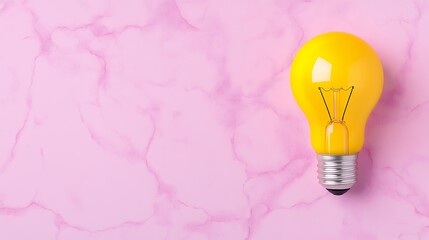 Illuminating Yellow Bulb On Pink Marbled Background