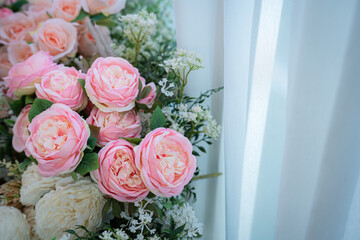 Valentine's day concept,close up Sweet color of artificial rose bouquet of red and pink roses Put with rose vase weddings interiors and decorations In a restaurant background