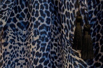 Fragment of clothing. Two black tassels. Dress.