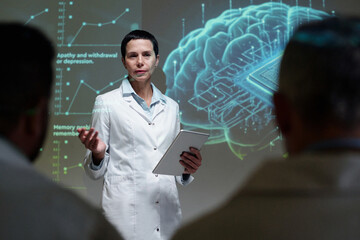 Front view portrait of mature woman as female neurologist speaking on brain implants during medical conference copy space