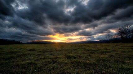 Obraz premium Dramatic sunset lighting up the sky above a vast grassy field with swirling clouds : Generative AI