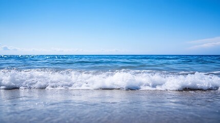 Stunning view of gentle ocean waves lapping against a sandy shore under a clear blue sky : Generative AI