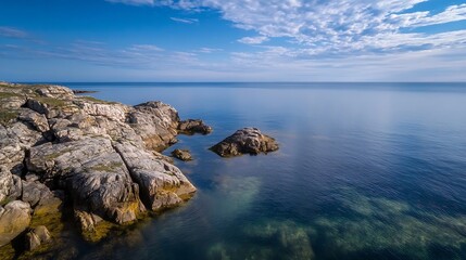 Breathtaking coastal landscape with clear waters and rocky shore under blue sky : Generative AI
