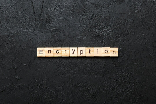 encryption word written on wood block. encryption text on table, concept