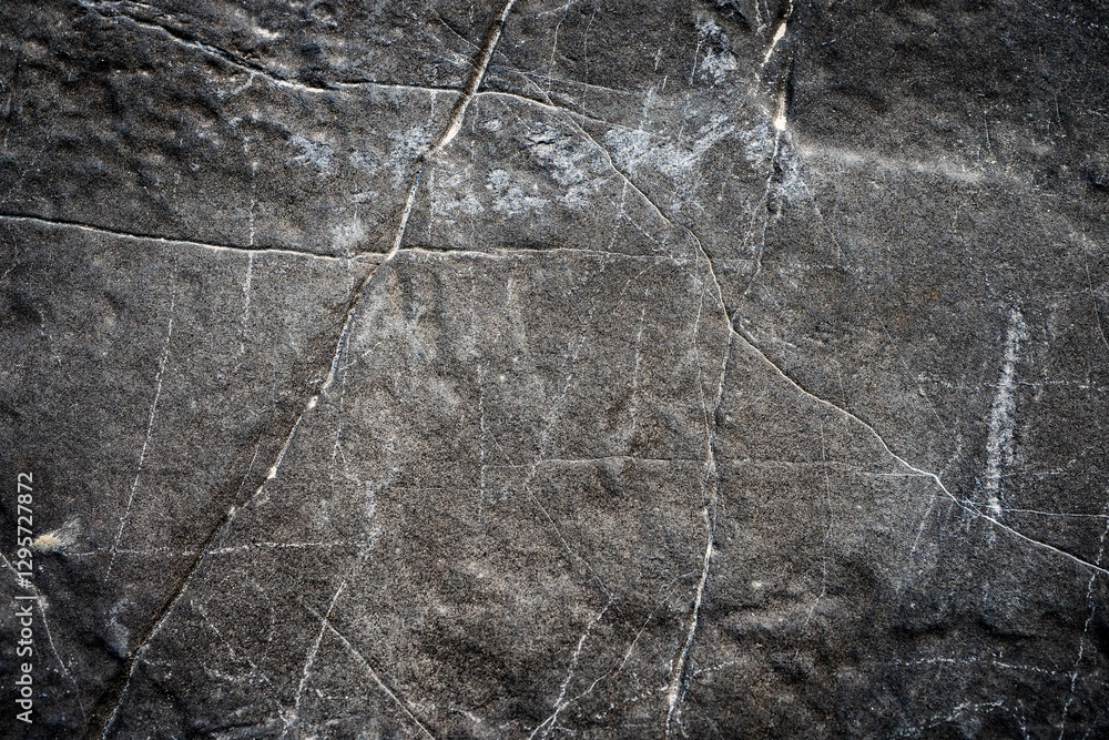Poster textured dark stone surface with natural cracks and patterns for background or design elements