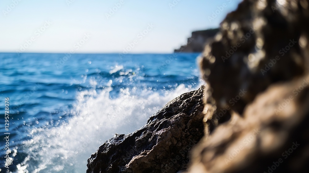 Aufkleber Dynamic ocean waves crashing against rugged rocks under bright clear sky on a sunny day : Generative AI