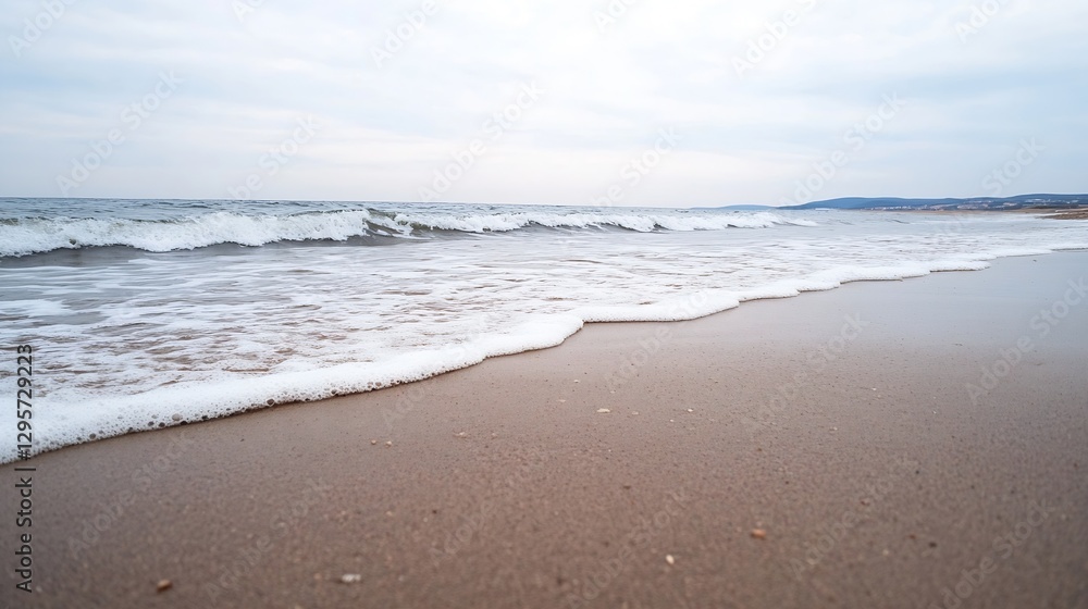 Aufkleber Serene beach view with gentle waves lapping at the sandy shore under a cloudy sky : Generative AI