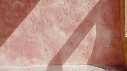 Soft Pink Textured Wall with Light and Shadow Play Creating an Abstract Minimalist Atmosphere