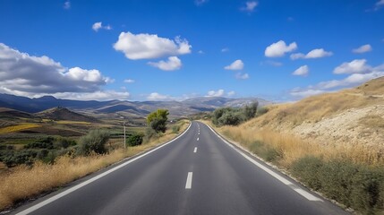 Naklejka premium Open road stretching through a sunny countryside landscape with fluffy clouds and distant mountains : Generative AI