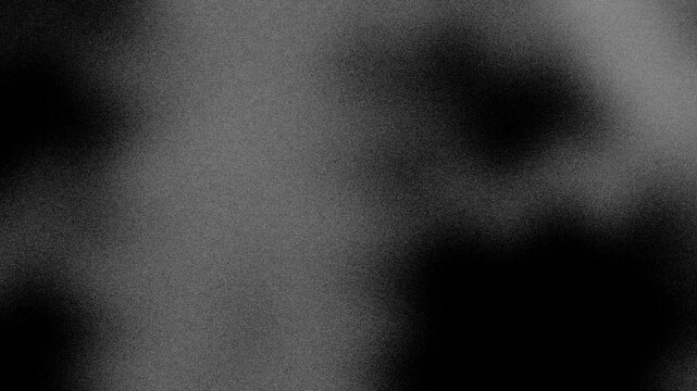 An abstract neutral black and white mottled grainy grunge texture motion graphic background loop design.