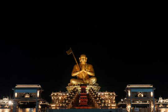 A stunning night view of the Statue of Equality, beautifully illuminated against the dark sky. The grand statue, dedicated to Sri Ramanujacharya, stands as a symbol of unity and spirituality
