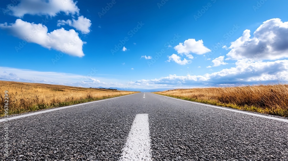 Poster straight open road leading into the distance under a blue sky with fluffy clouds : generative ai