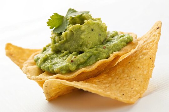 nachos chip with guacamole dip on white - Powered by Adobe