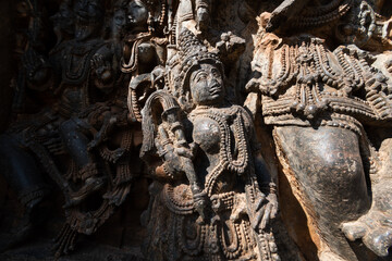 Elaborate sculptures of various deities adorn the stone walls of Hoysaleshwara temple, highlighting exceptional artistry and historical significance in Halebidu, Karnataka