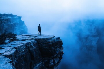 A lone adventurer standing at the edge of an ancient
 mist covered canyon.