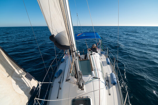 Senior man sailing on sailboat in calm sea on sunny day