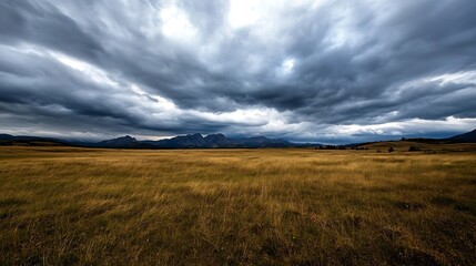 Dramatic Sky Over Open Field with Rolling Hills and Mountains in Distance : Generative AI