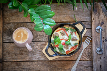 Omelette with cutlet, sun-dried tomatoes and basil