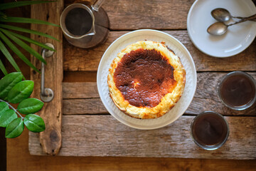 basque cake with coffee. Wooden background. San Sebastian