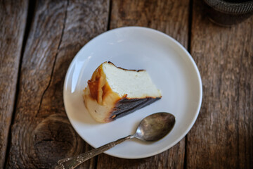 piece of basque cake with coffee. Wooden background. San Sebastian