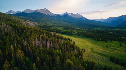 Obraz premium Breathtaking Aerial View of Lush Green Forests and Majestic Mountain Range Under a Soft Sunset Sky : Generative AI