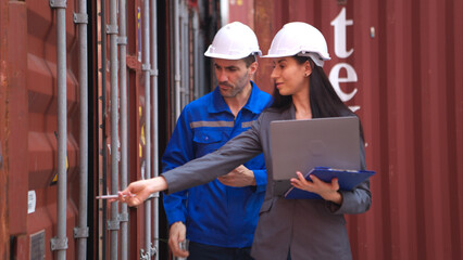 Container manufacturing manager and businesswomen survey the area to plan the storage