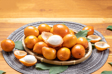 Achacha fruit or Garcinia humilis orange color tropical fruit egg-shaped on wooden background