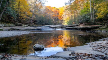 Fototapeta premium Tranquil autumn scene with vibrant foliage reflecting in calm waters of a forest creek