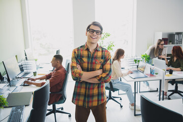 Photo of positive good mood young specialists arms folded creating start up together modern gadget...