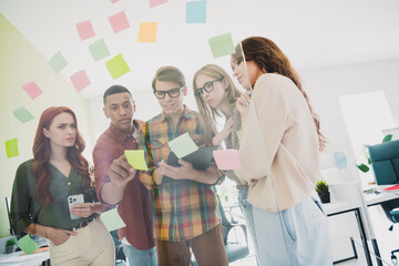 Photo of group successful specialists searching ways to make process cheaper cooperation working...