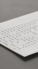 Close up view of braille text on white paper isolated on grey