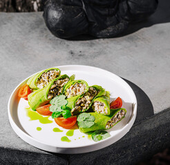 Herb-filled green rolls and cherry tomatoes served al fresco